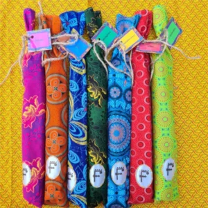 7 Incense Scents Set in Colourful ShweShwe Fabric Bags with various ShweShwe patterns, displayed on a vibrant yellow patterned background.