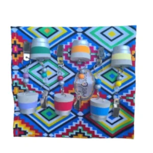 Handcrafted 6-piece Africa-inspired Rainbow concrete table weights with geometric beaded design on a vibrant patterned cloth, perfect for outdoor or indoor use, adding a touch of cultural elegance and practicality.